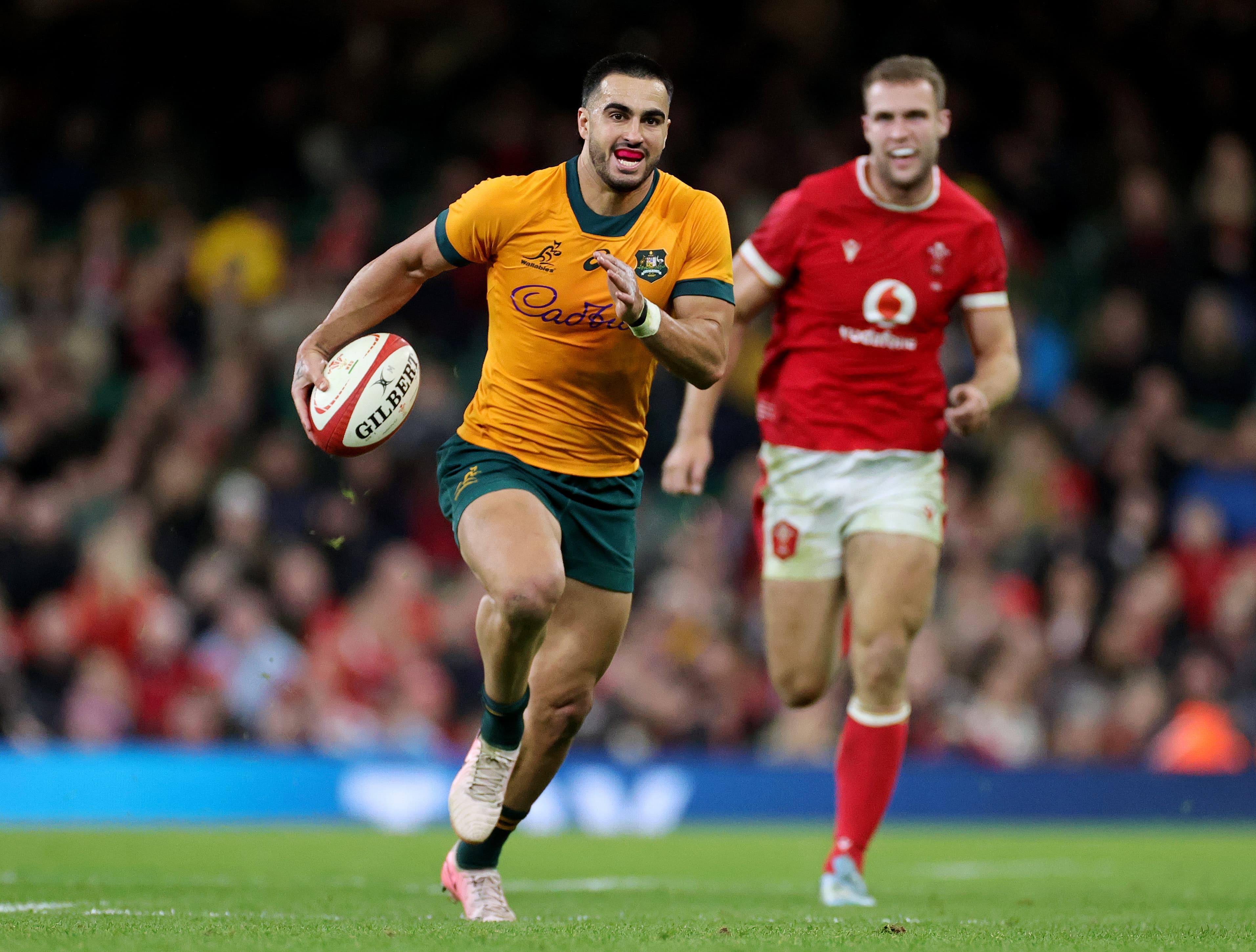 Tom Wright on his way to scoring one of his three tries in Wales. Photo: Getty Images